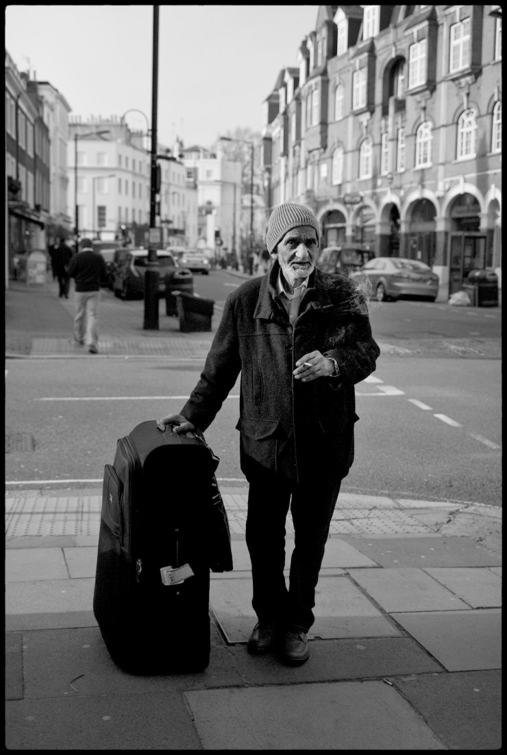 Indian man smoking and waiting, London
