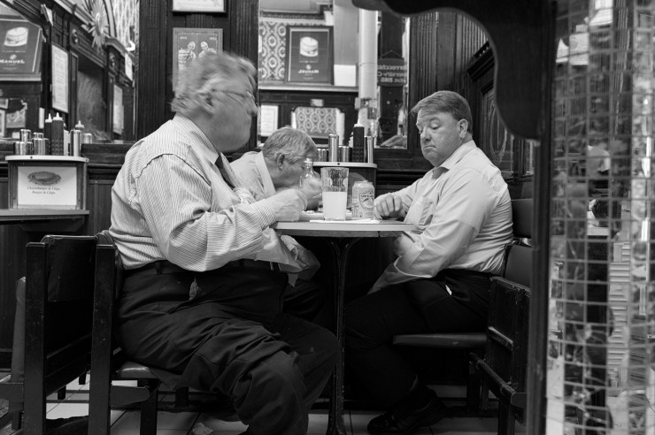 three big men enjoying food